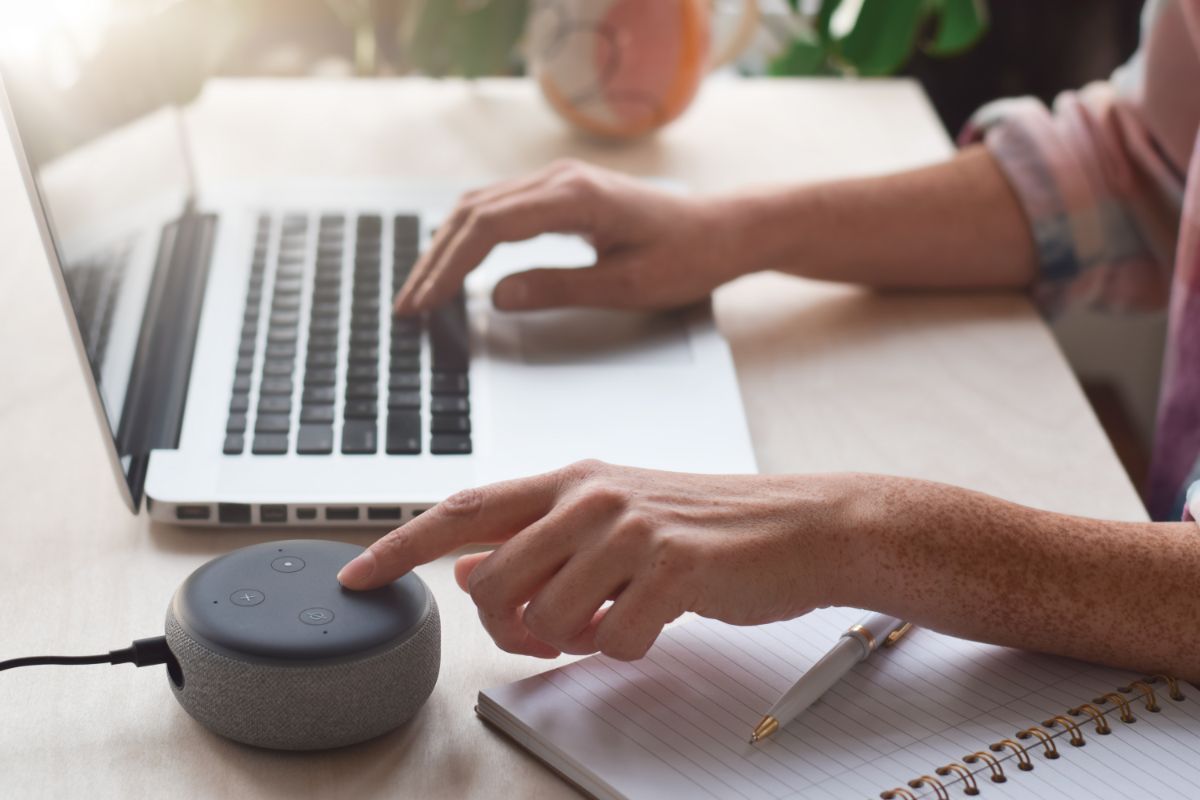 a woman turning alexa connecting to her laptop