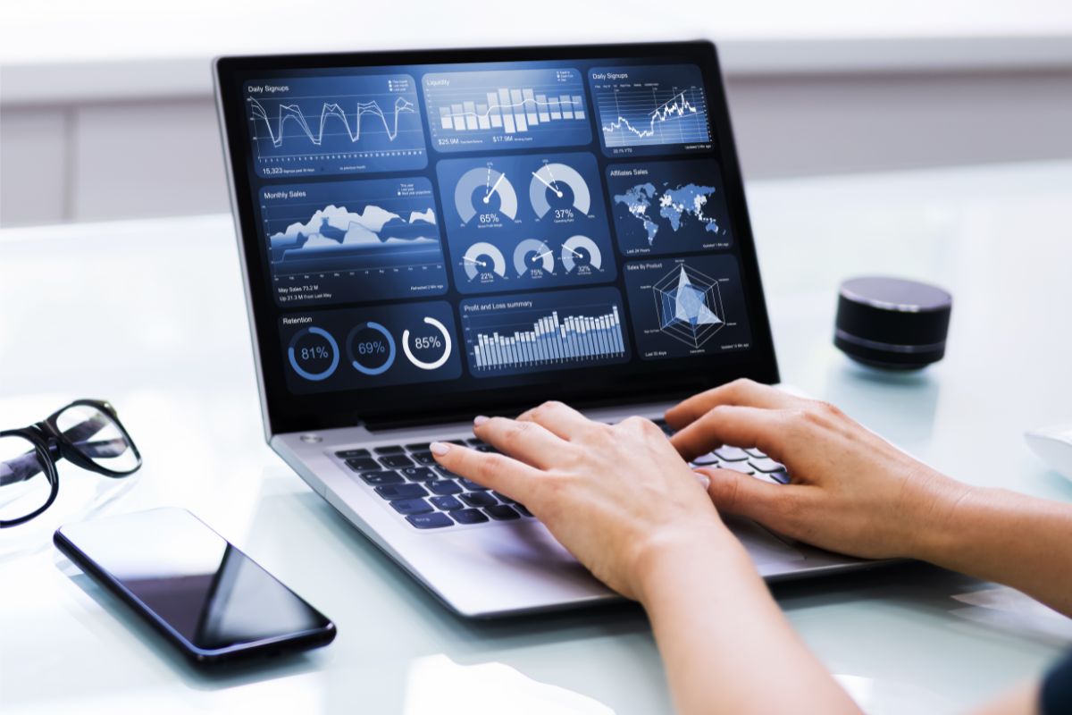 a laptop with business metrics on the screen