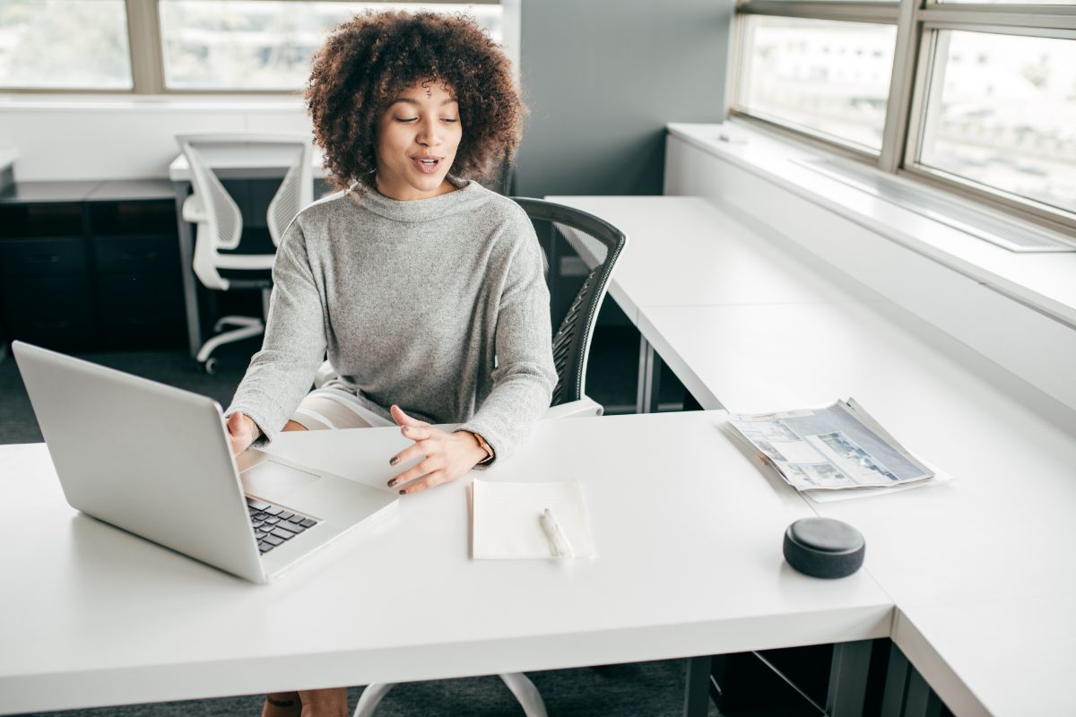 curly haired woman working on an office desk