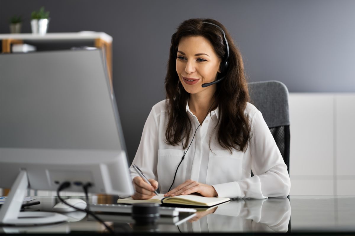 woman using a headset on a call on her desktop