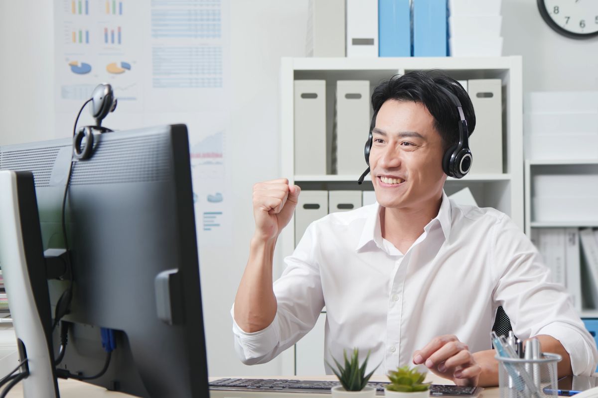 man in a white shirt having a video call with his client