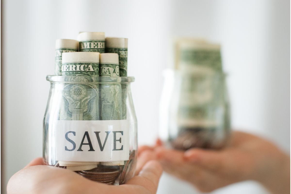 a jar labeled save with some cash inside