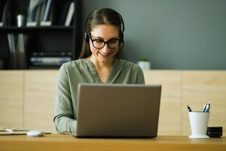 happy virtual assistant working on her laptop