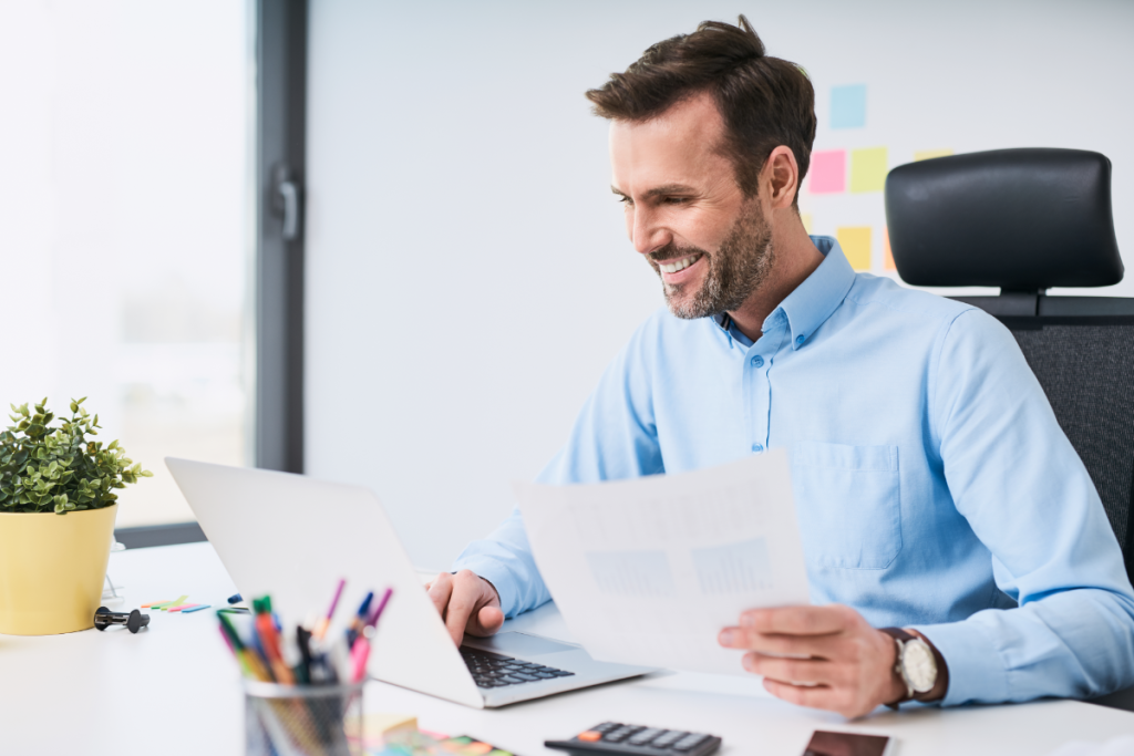 Man holding data sheets in his office